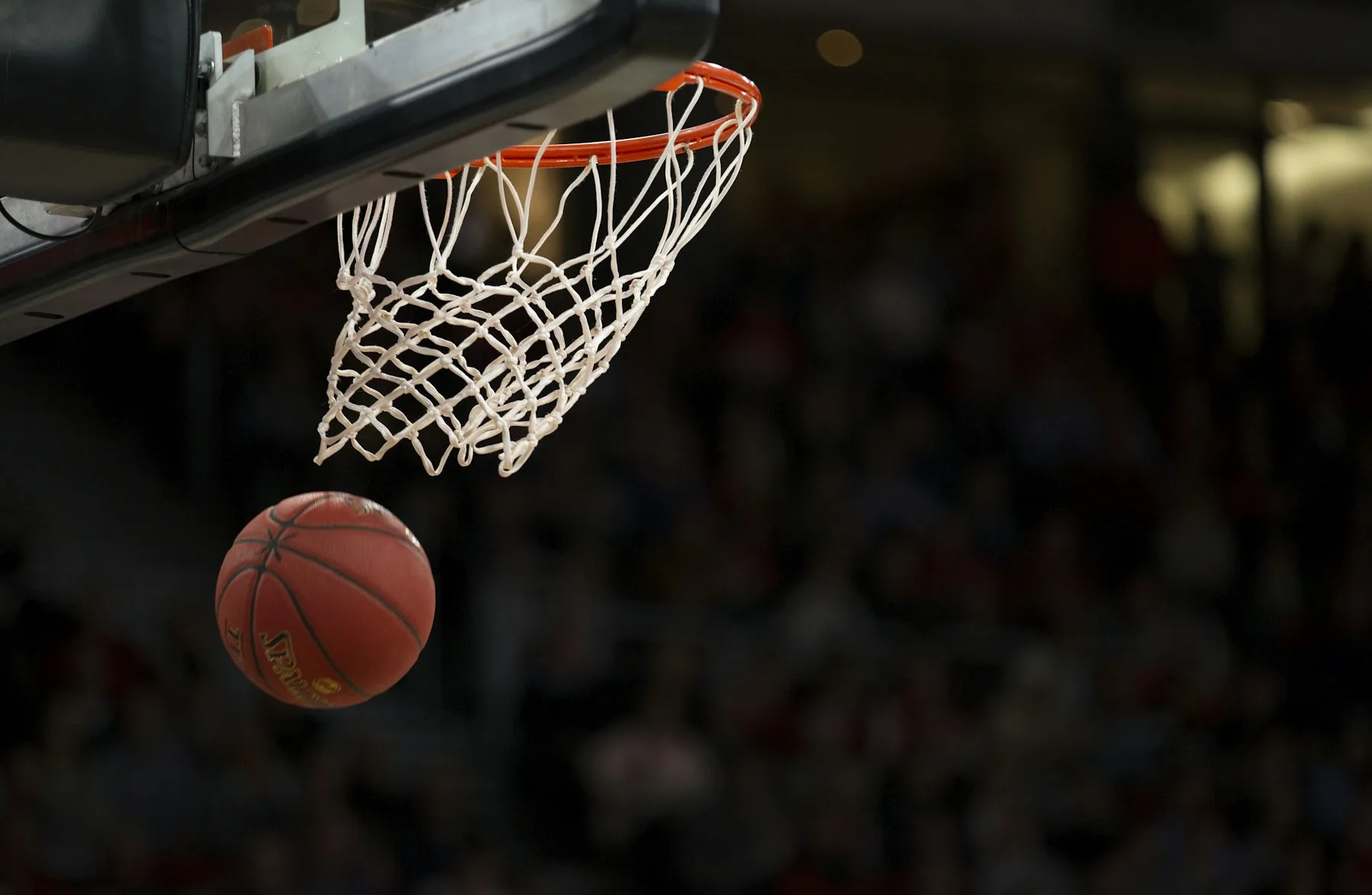 Basketball and hoop on an indoor court