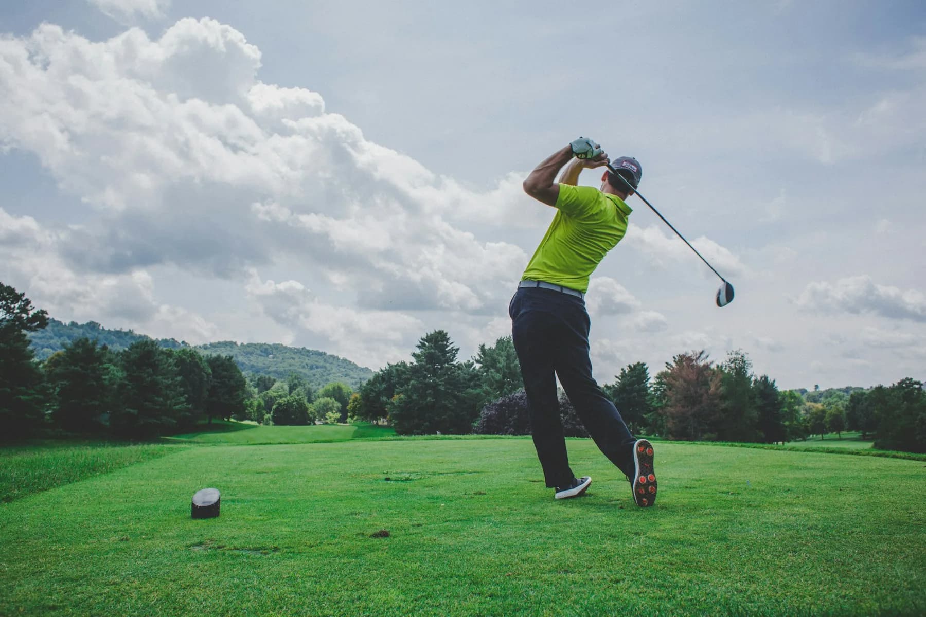 Golfer driving on a fairway