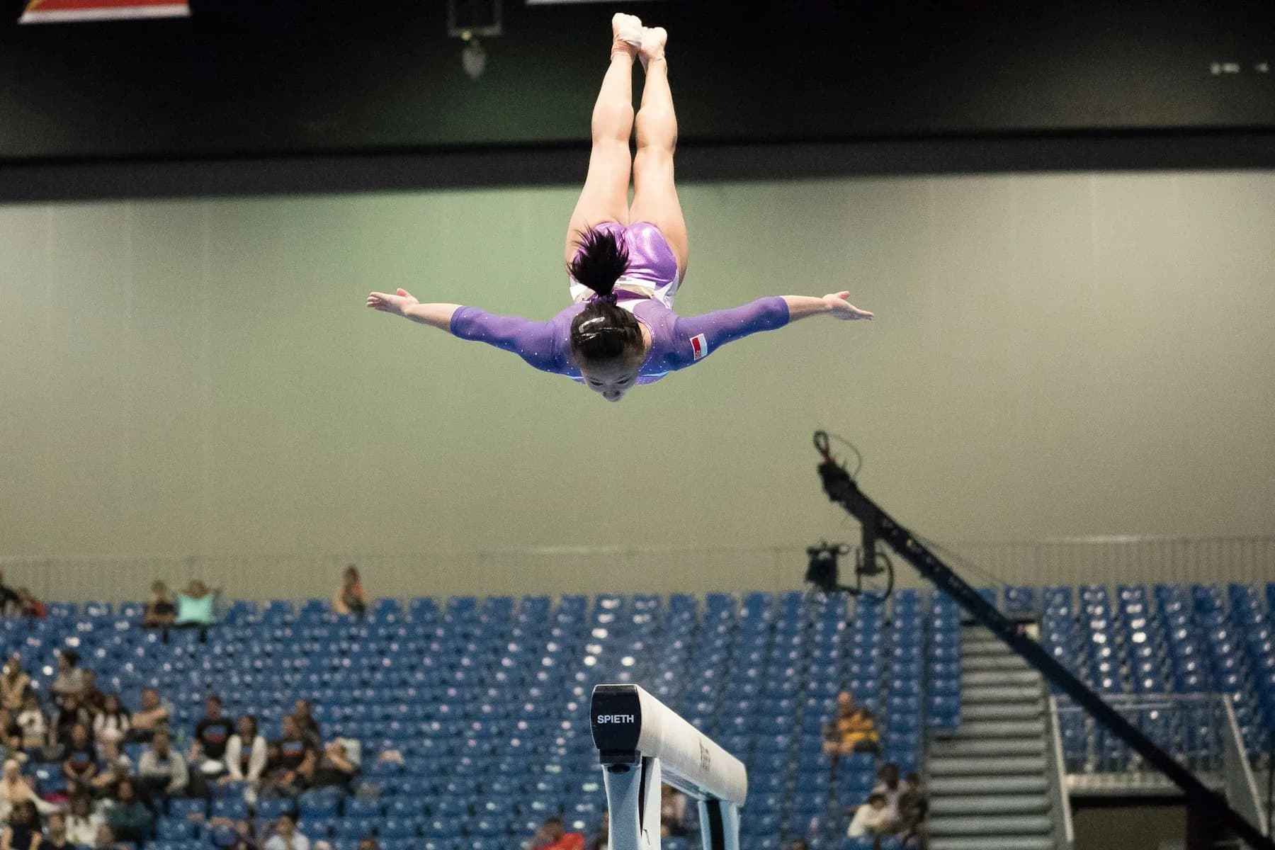 Gymnast performing on a balance beam