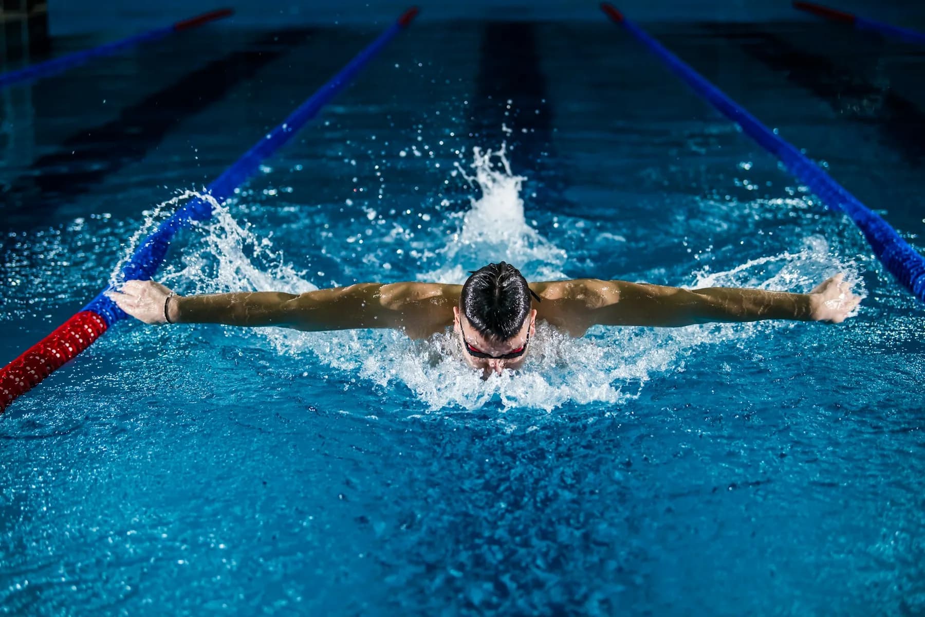 Swimmer racing in a marked pool lane